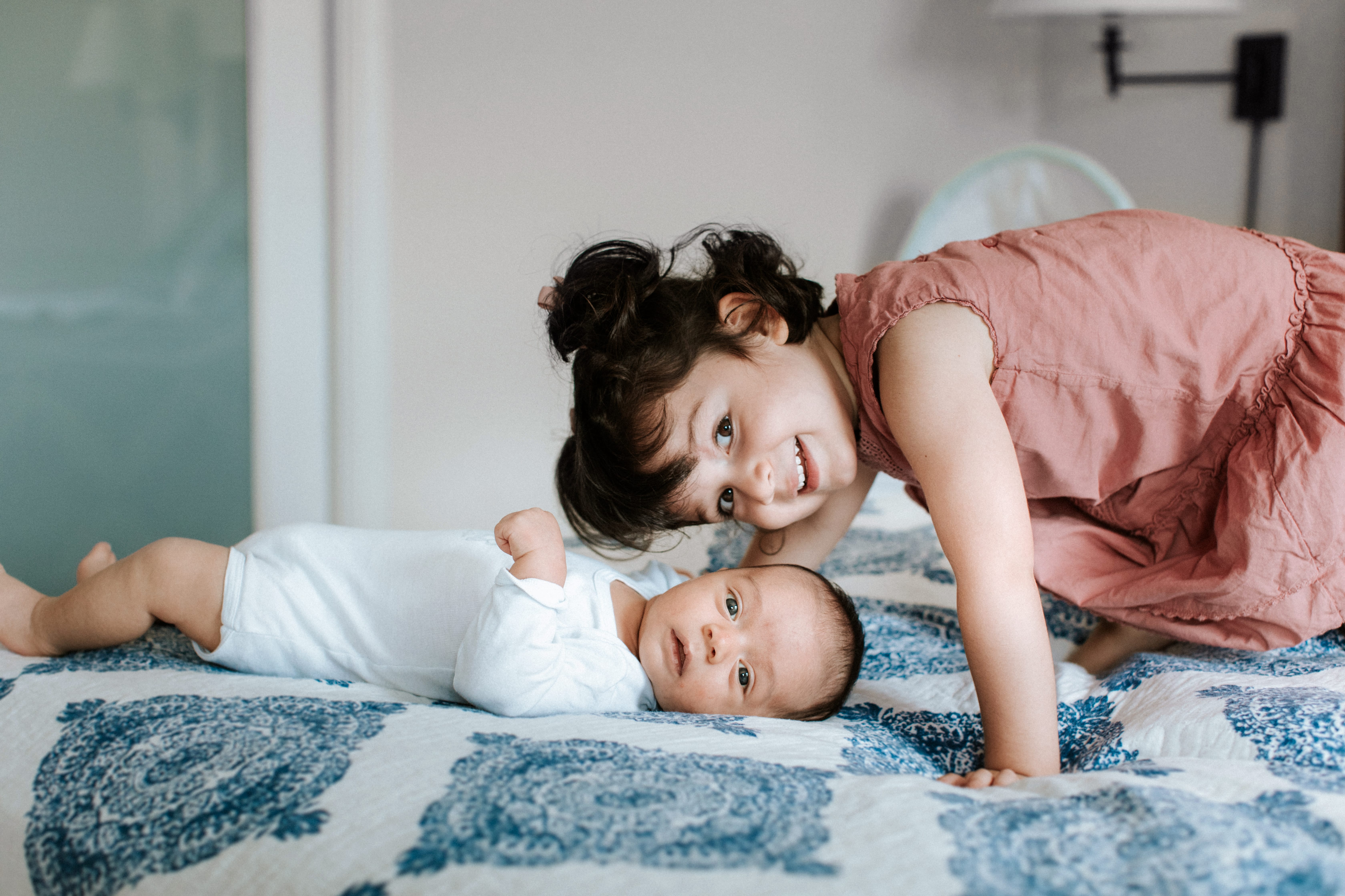 New baby and sister in home portrait