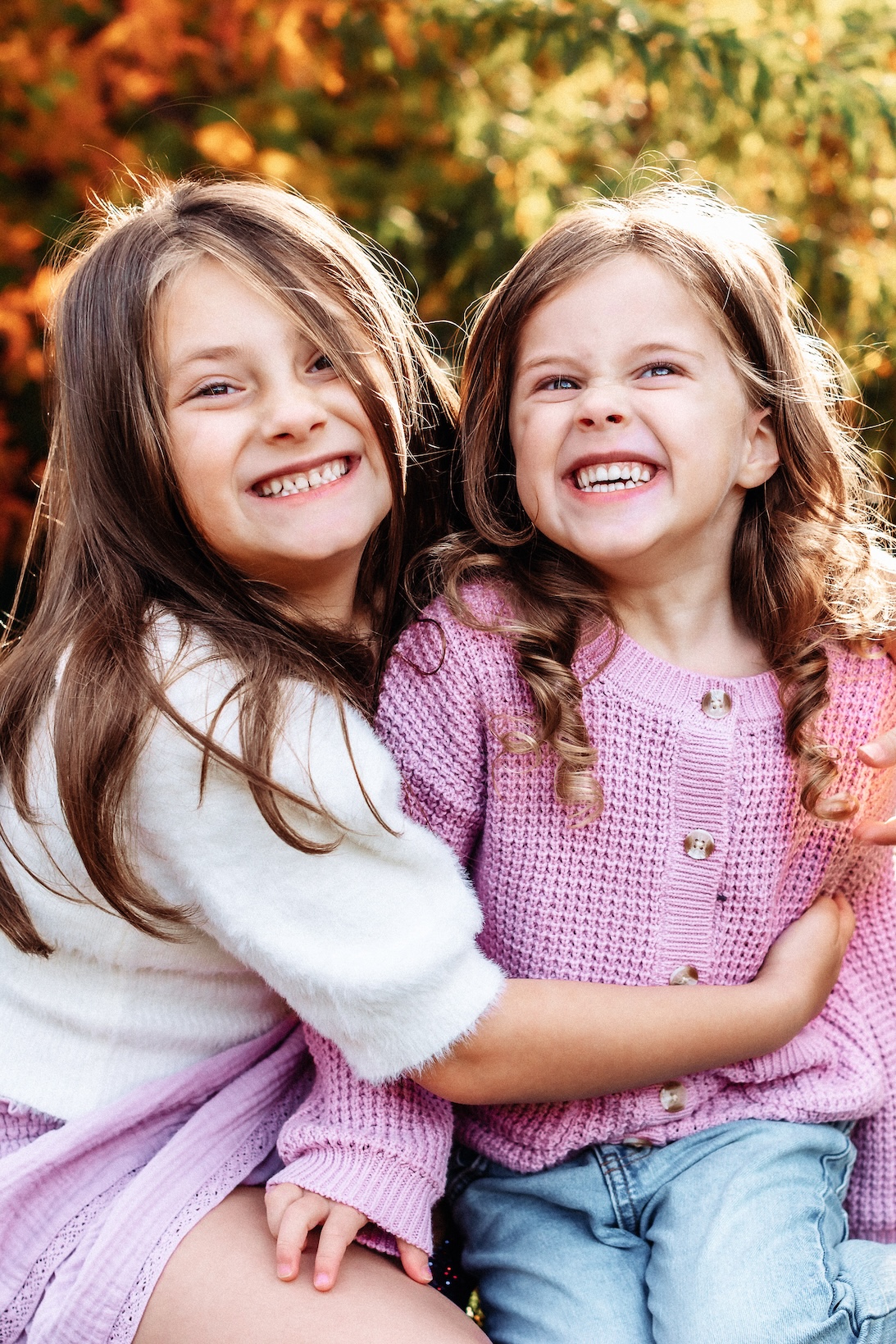 Siblings smiling together during a family session