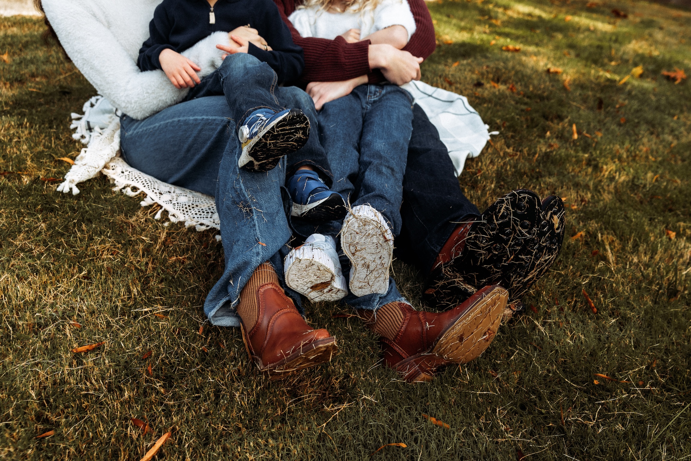 A closeup of a family with a focus on their feet during an outdoor session