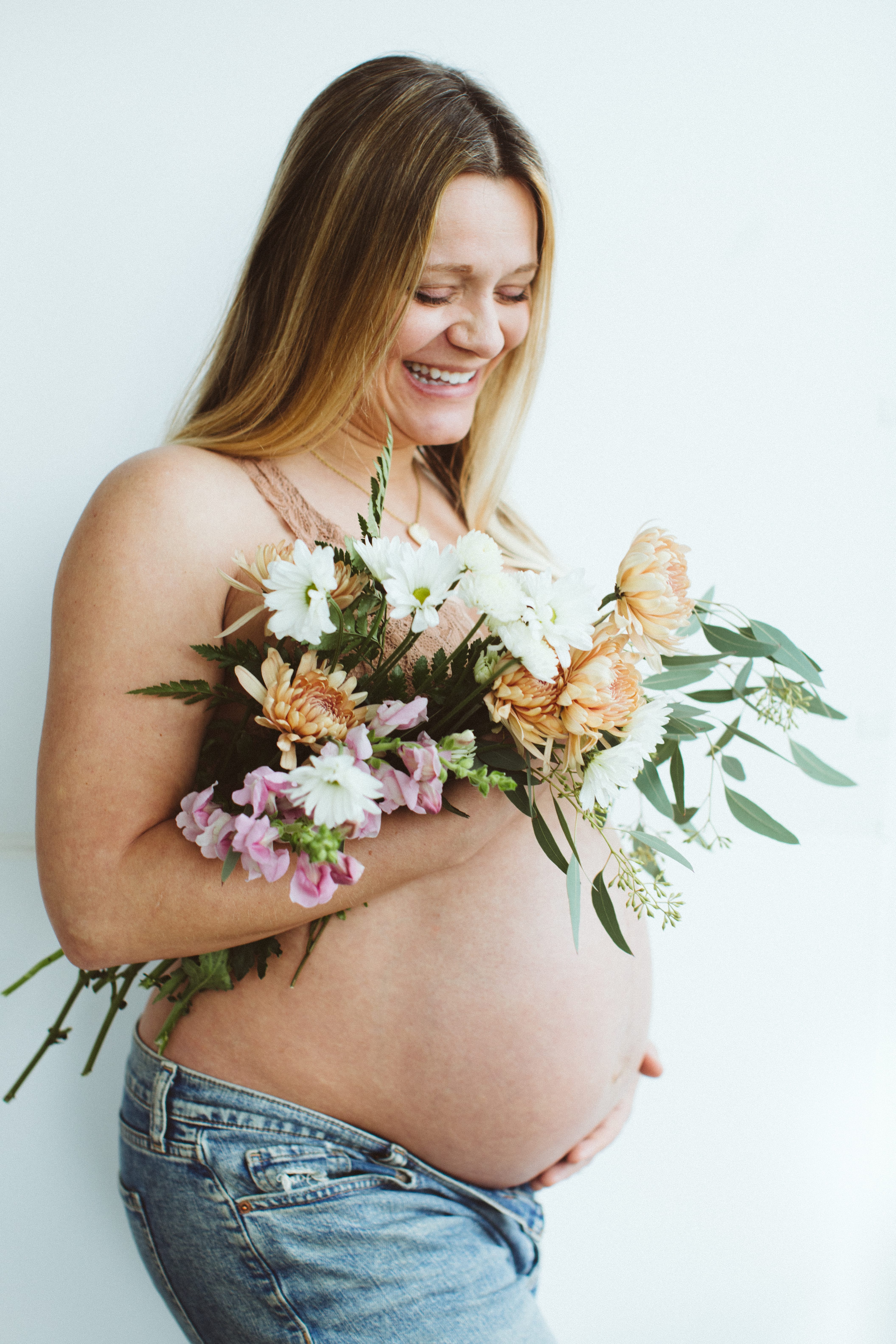 Expectant mother holding flowers