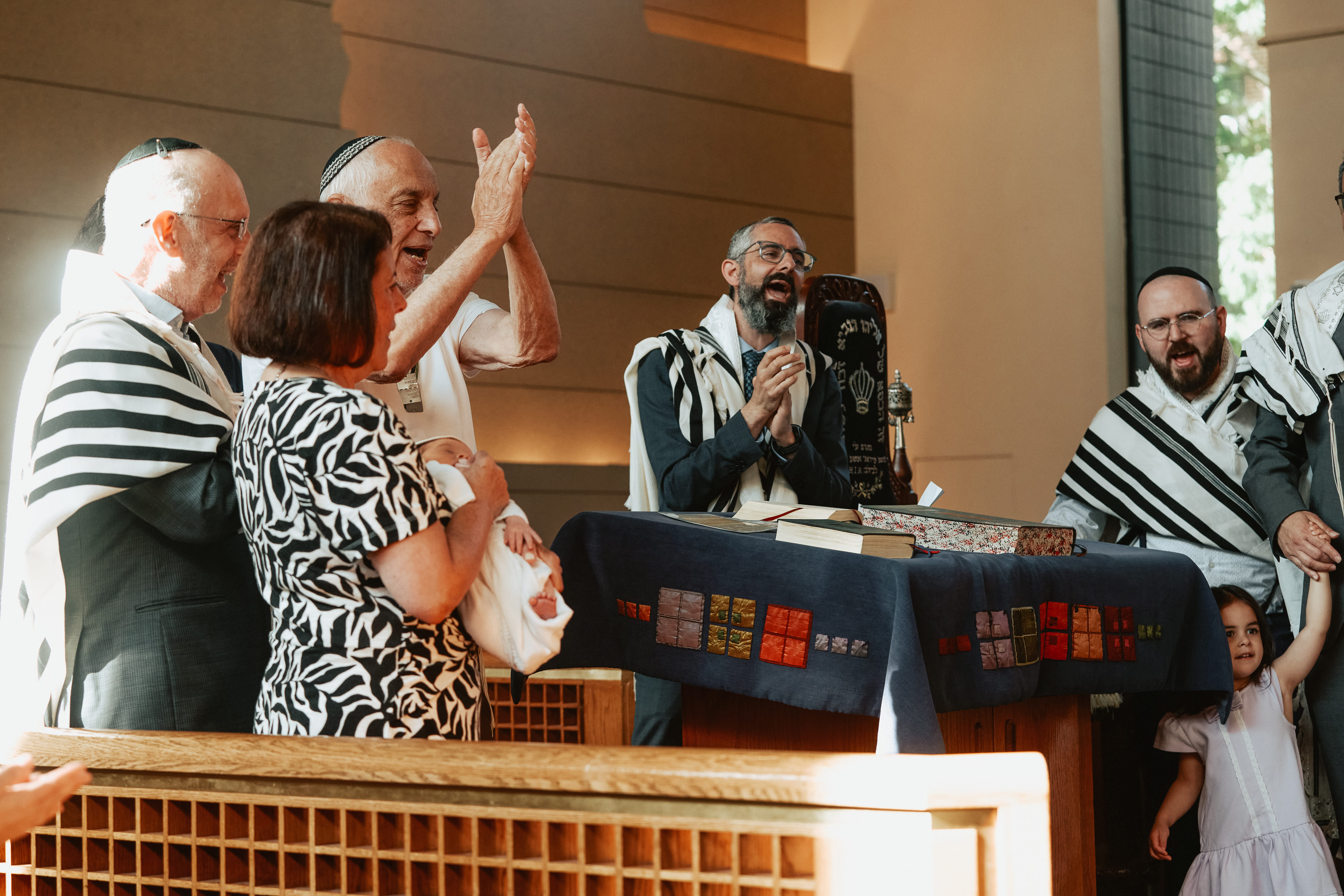 Rabbi and family together during a Jewish ceremony at a synagogue in NYC