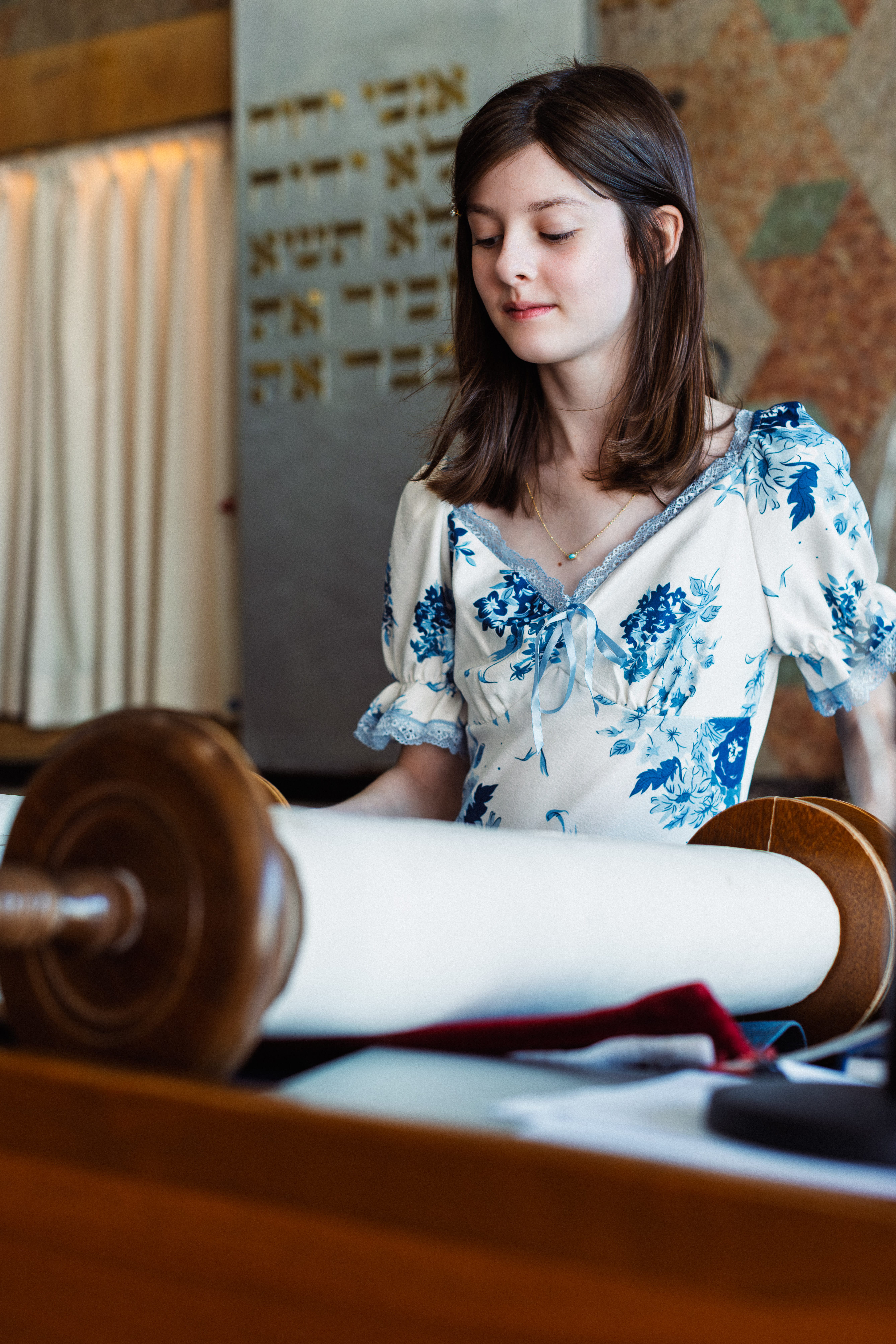 Young woman reading from the Torah during her Bat Mitzvah ceremony